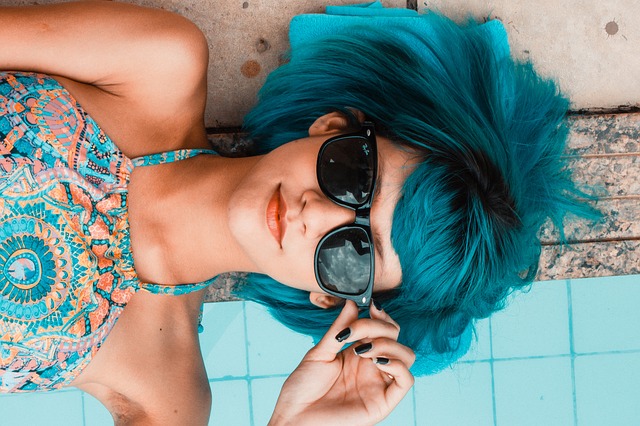 Picture of a woman with blue hair and sunglasses